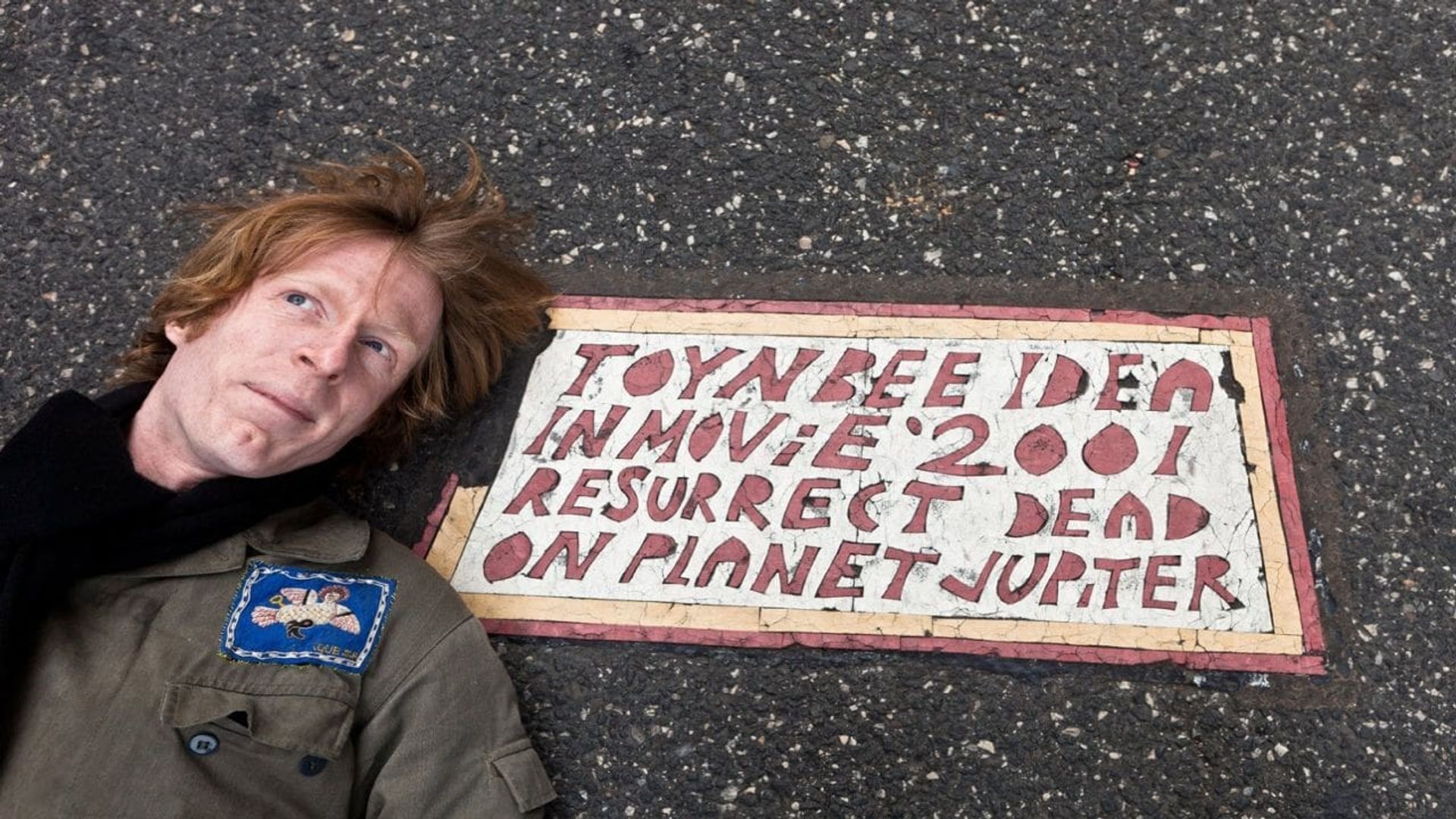 Resurrect Dead: The Mystery of the Toynbee Tiles Backdrop