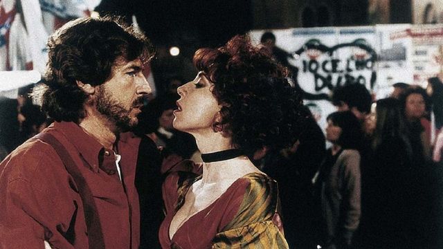 The Blue Collar Worker and the Hairdresser in a Whirl of Sex and Politics Backdrop
